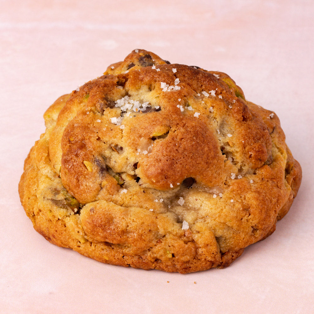 NY Style Pistachio Toffee Cookies with golden edges and gooey